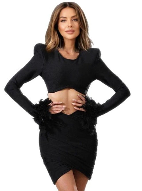 Black bandage crop top and skirt with feathers